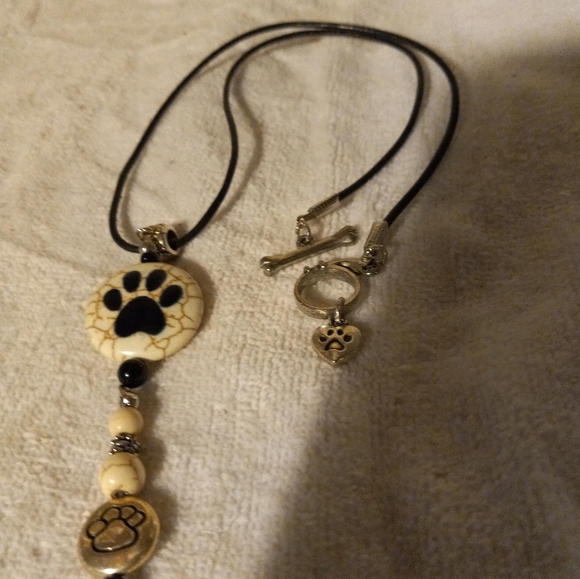 Handmade black leather cording necklace with cream bead with 🐾 print design. - Picture 2 of 4